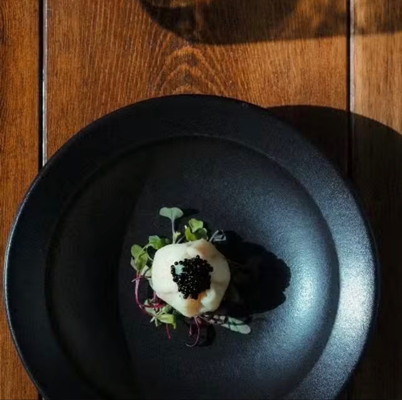 Caviar-topped bite plated for a private chef service