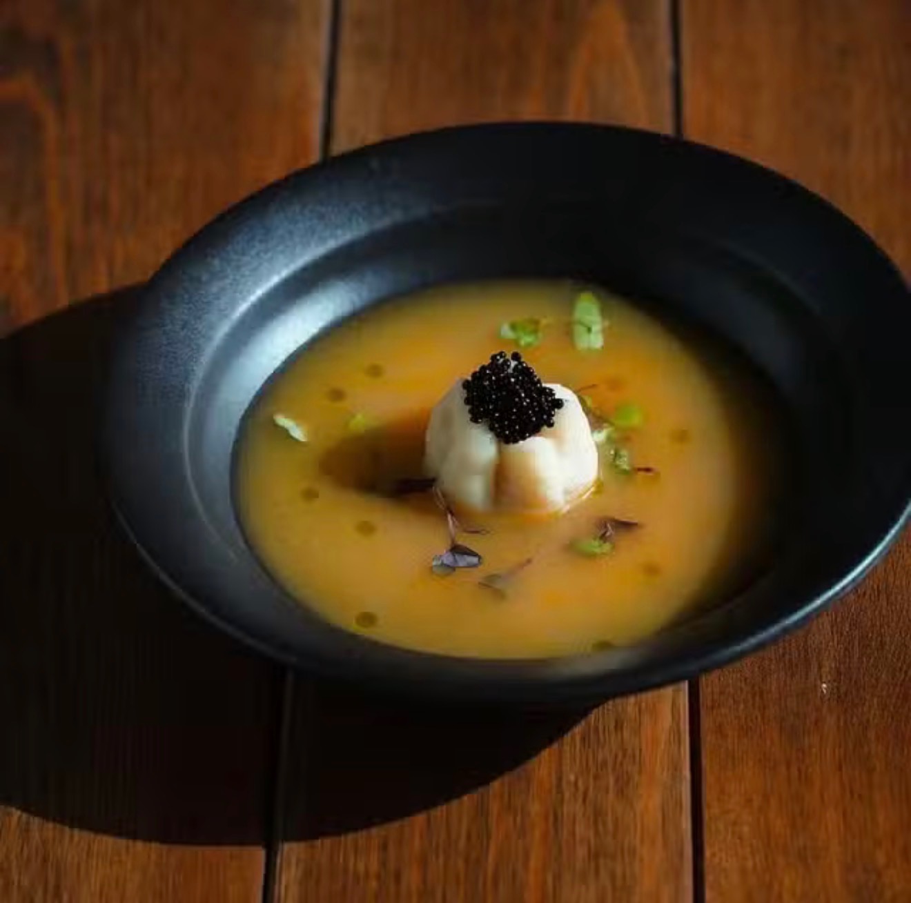 Golden pepper broth with caviar served at a private dining experience